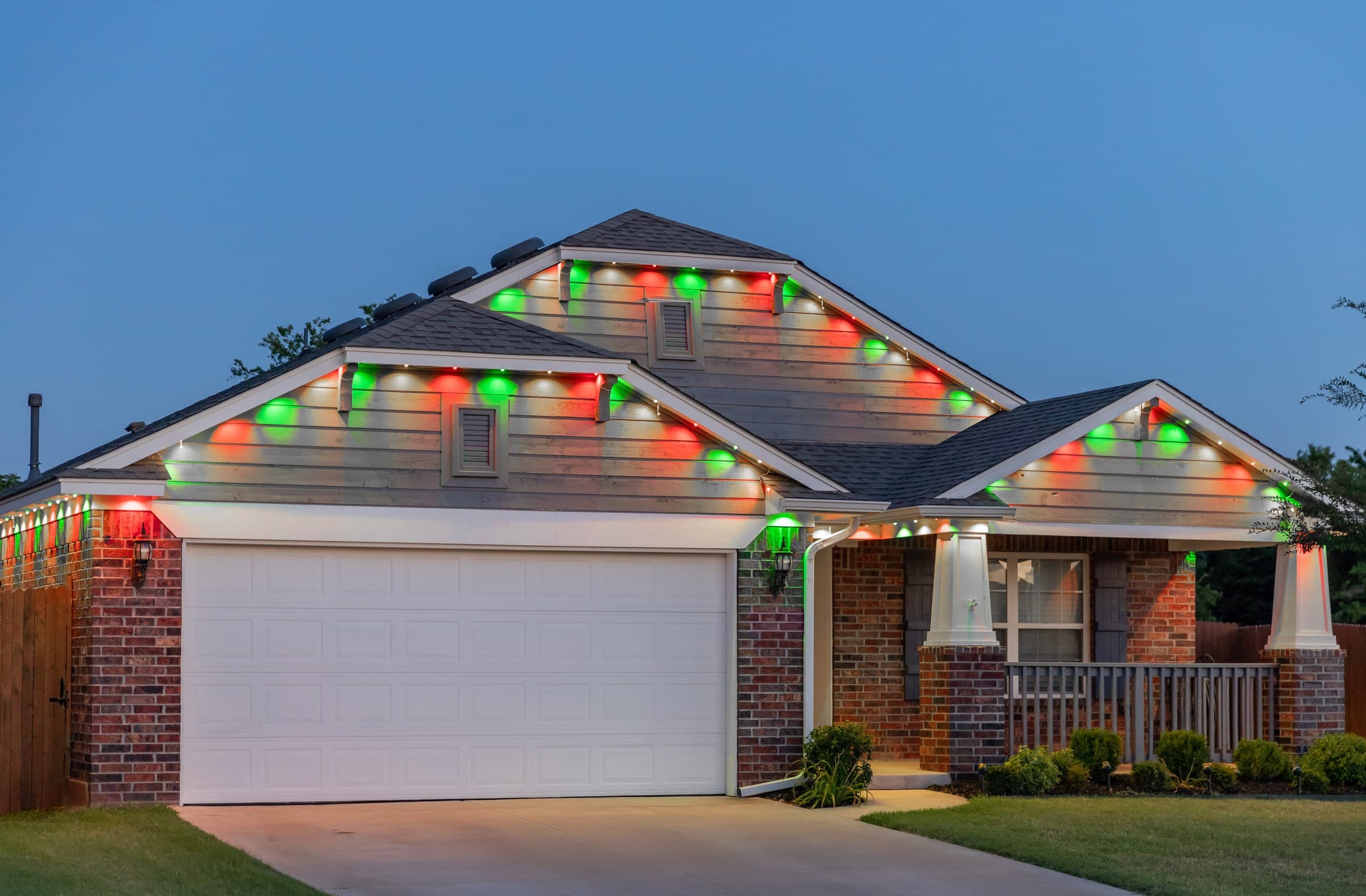 A home with the roofline alternating red and green for a seasonal display