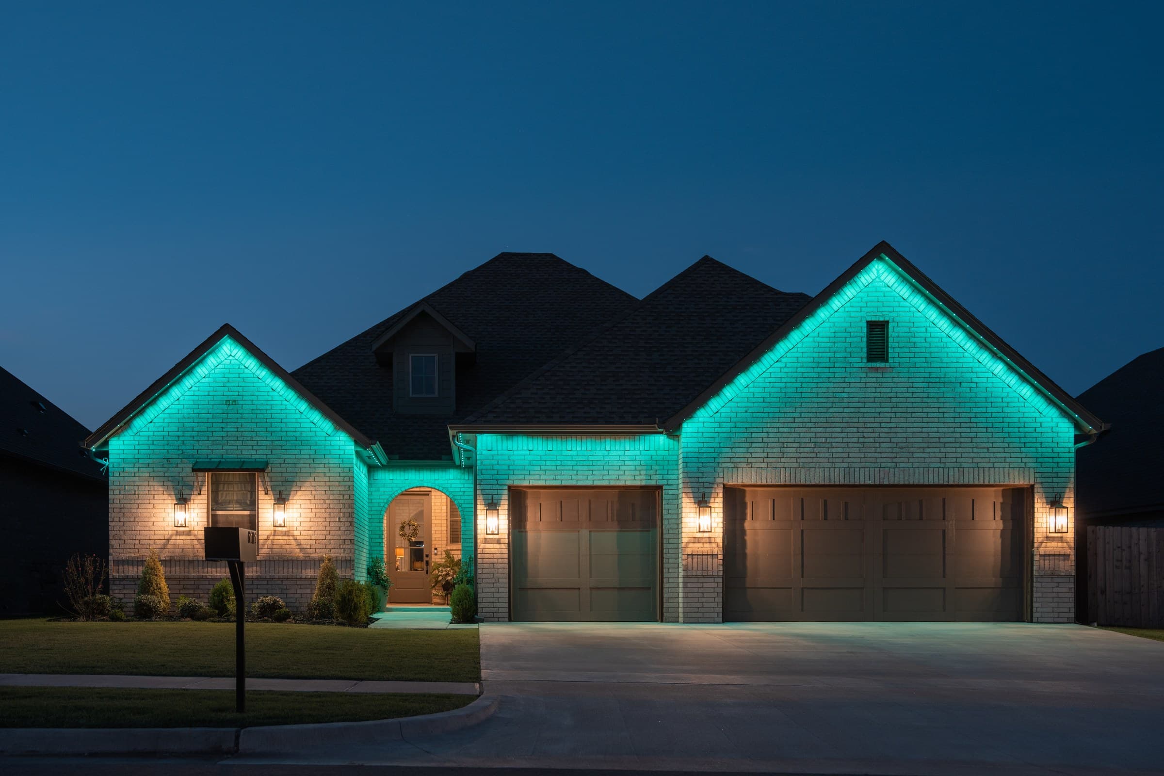The same two-gable home with the entire roofline set to a single solid teal color